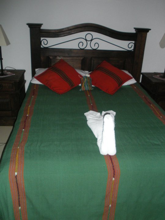 Our bed with handmade textile blankets